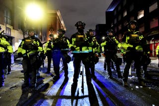 Minnesota Conservation Officers stand in formation as protesters were given the order to disperse after marching in protest against ICE